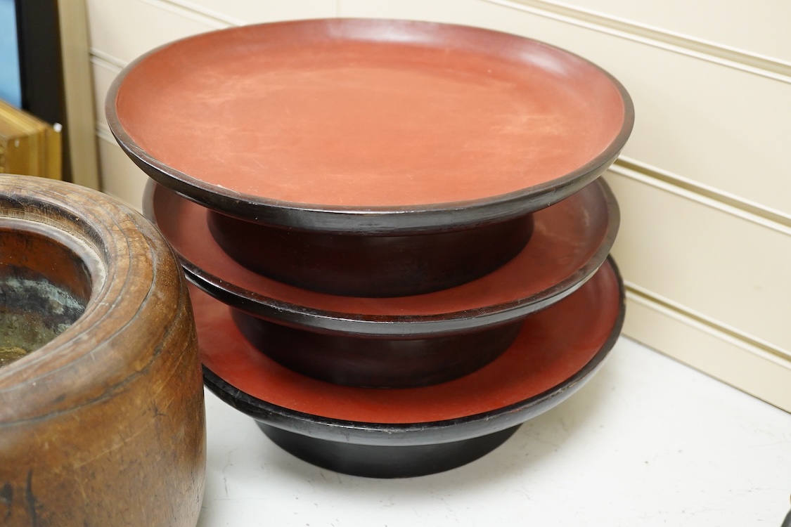 A Japanese lacquered paulownia wood hibachi, 20.5cm high and three Burmese lacquer stands
